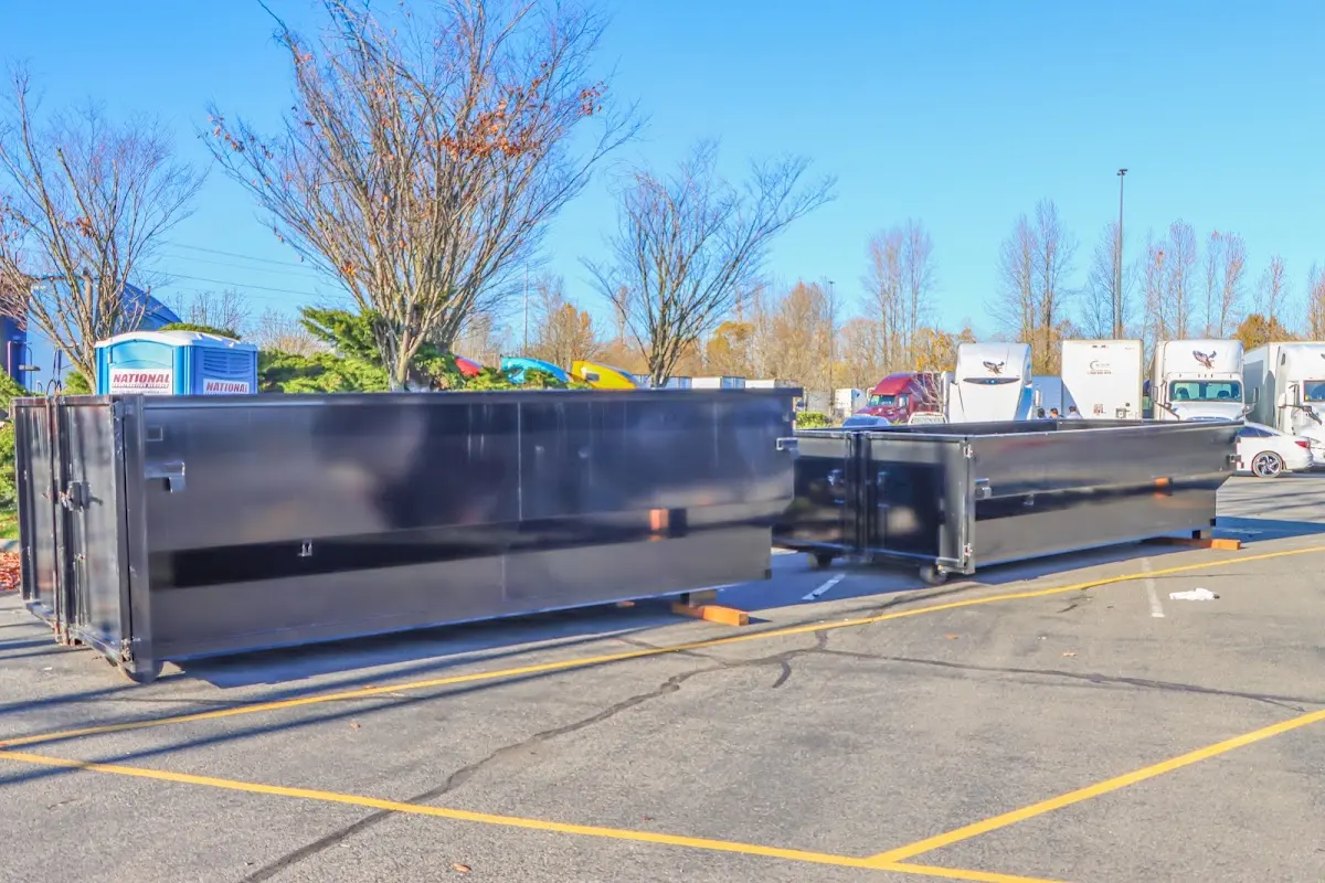 Professional dumpster rental service with roll-off container on residential driveway in Snowflake